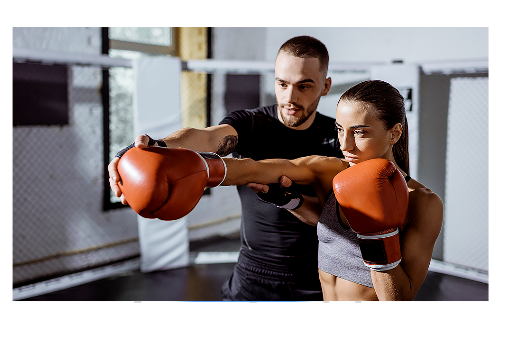 Male Personal Trainer showing a female trainer proper boxing jab stance