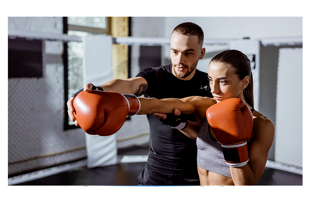 Male Personal Trainer showing a female trainer proper boxing jab stance