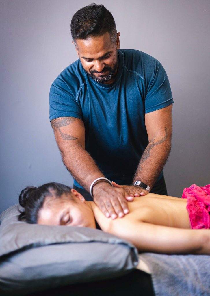 Singh Swaley giving a female client a back massage